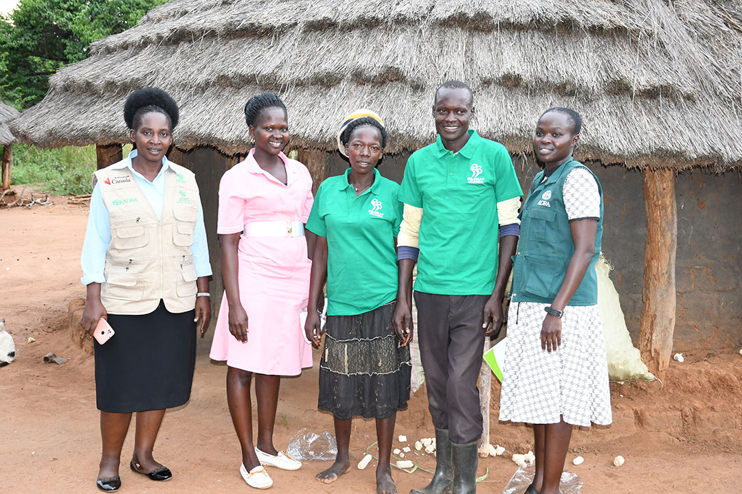 Vincent Okwera Lapi and his wife (wearing Mildmay Uganda Branded T-shirts) interacts with a team from the TOGETHER at his home.